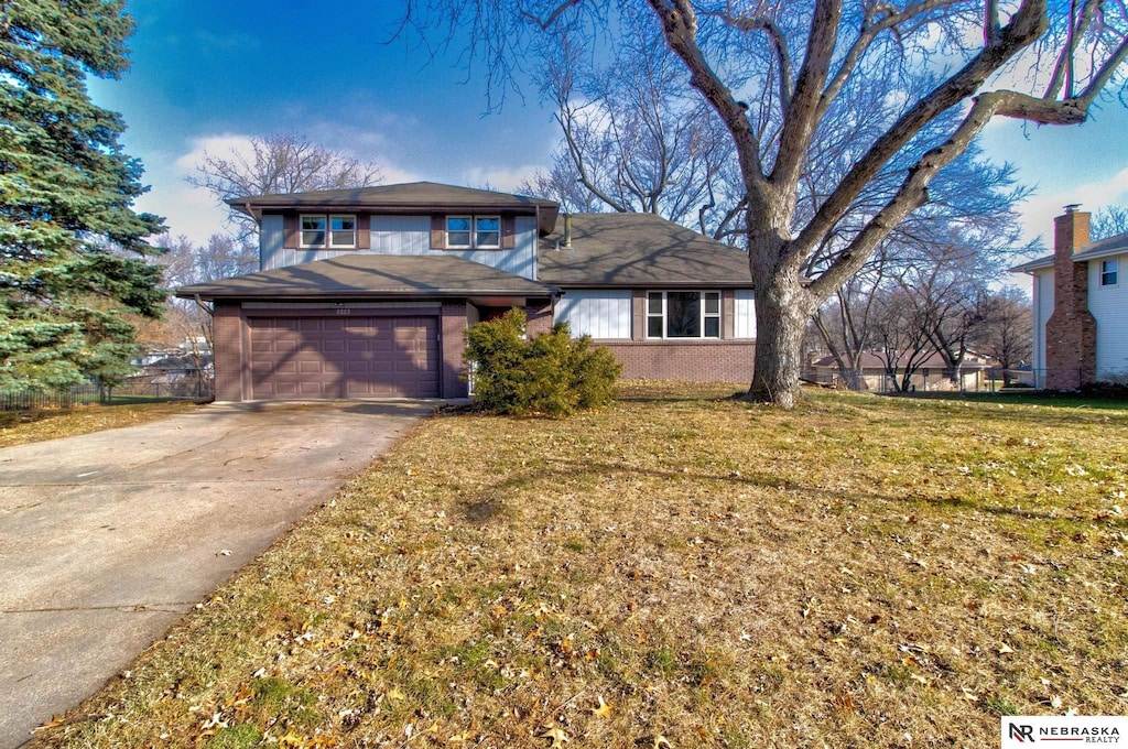 view of front of home with a garage and a front lawn