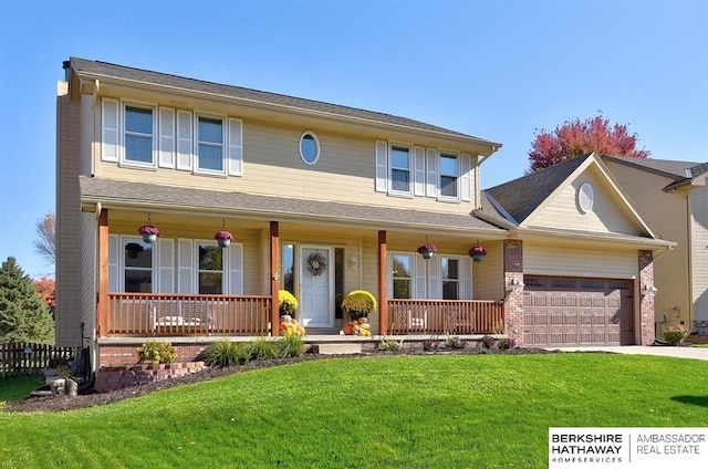 view of front of property featuring a front lawn, covered porch, and a garage