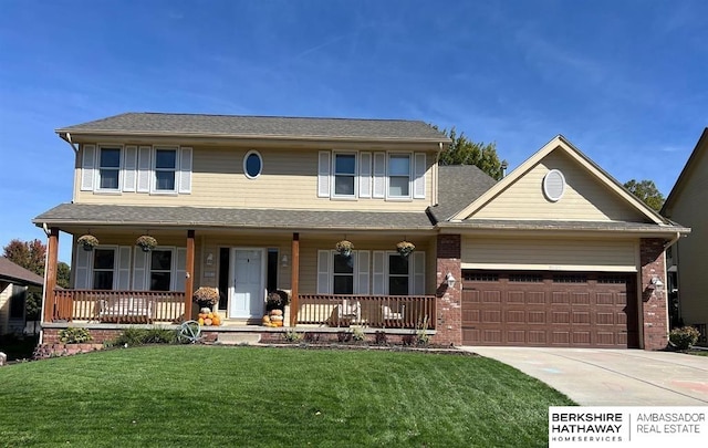 view of front facade featuring a porch, a garage, and a front lawn