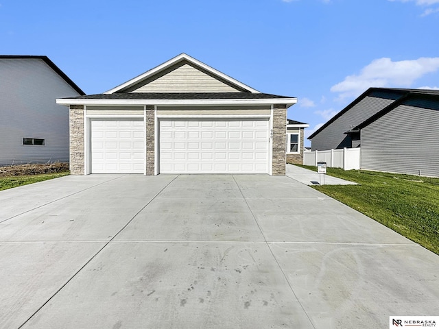 view of front of house with a garage and a front lawn