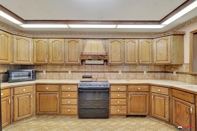 kitchen featuring black appliances, a raised ceiling, sink, decorative backsplash, and a textured ceiling