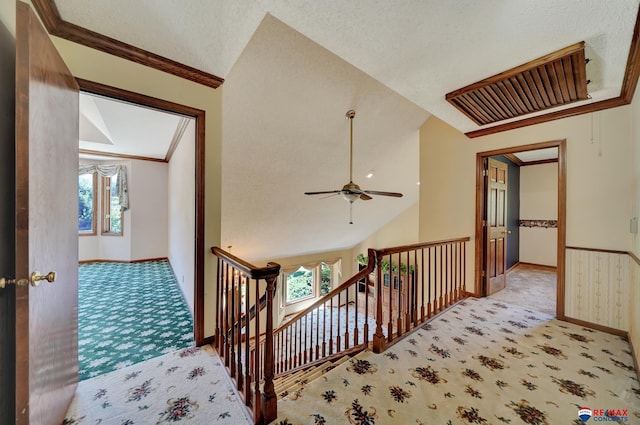 corridor featuring light carpet, a textured ceiling, and vaulted ceiling