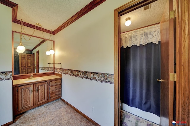 bathroom with vanity, a textured ceiling, vaulted ceiling, and crown molding