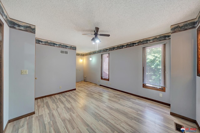 unfurnished room featuring a textured ceiling, light hardwood / wood-style floors, and ceiling fan