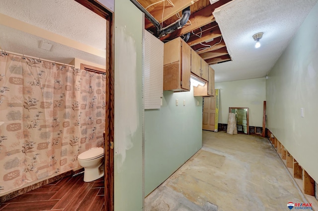 bathroom with concrete floors and toilet