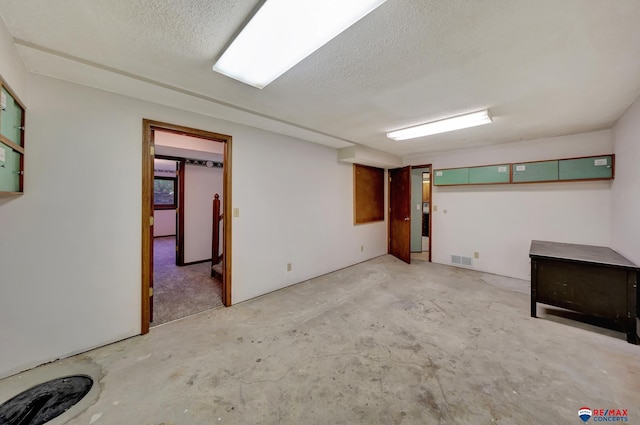 basement featuring a textured ceiling