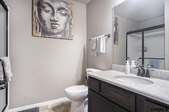 bathroom with tile patterned floors, vanity, toilet, and a shower with shower door