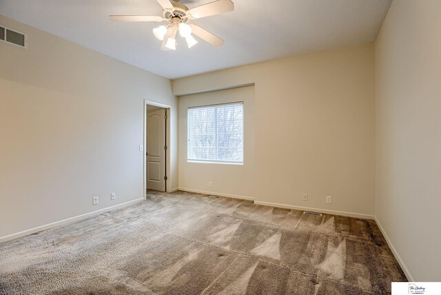 carpeted spare room featuring ceiling fan