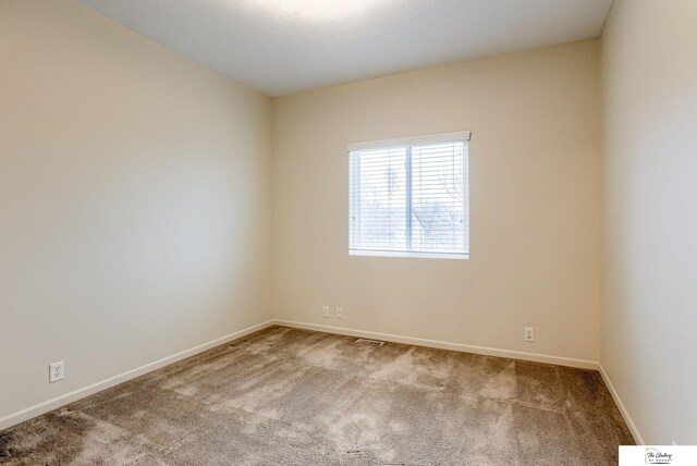 unfurnished room featuring carpet flooring