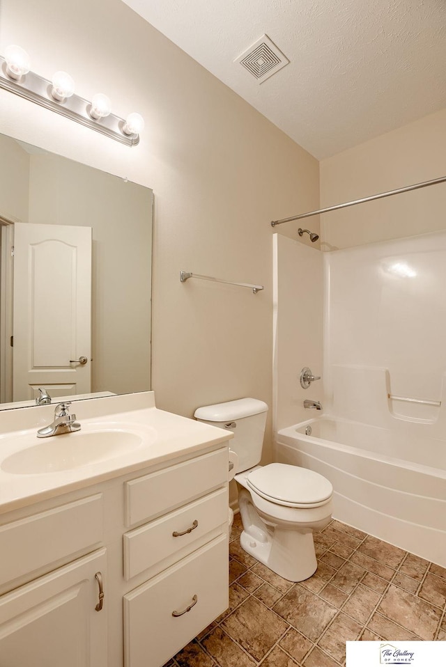 full bathroom with vanity, shower / bathing tub combination, a textured ceiling, and toilet