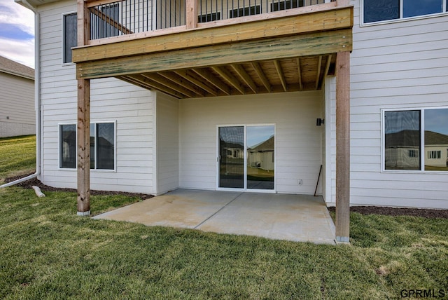 rear view of property featuring a patio and a lawn