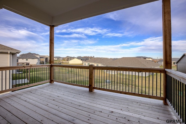 wooden terrace featuring a lawn