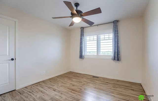 spare room with light hardwood / wood-style flooring and ceiling fan