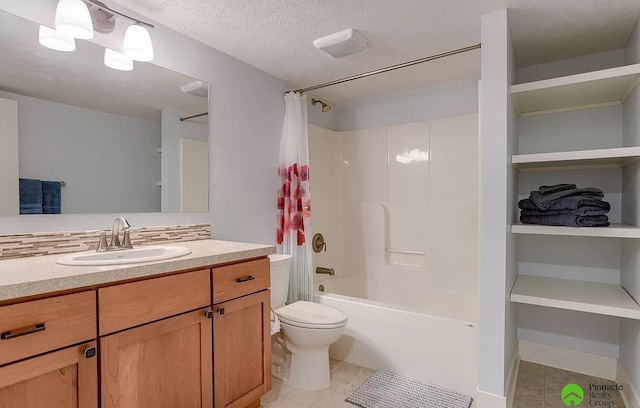 full bathroom with vanity, tile patterned floors, toilet, a textured ceiling, and shower / tub combo