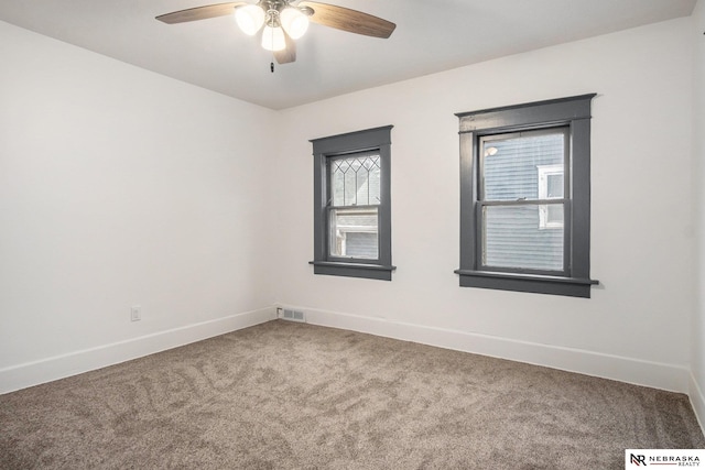 unfurnished room with ceiling fan and carpet floors