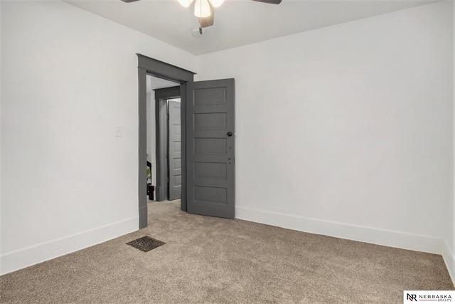 spare room featuring ceiling fan and carpet floors