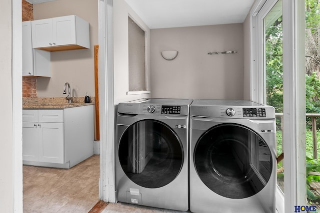 washroom featuring washer and clothes dryer and sink