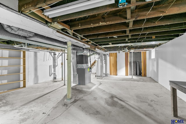 basement featuring heating unit and gas water heater