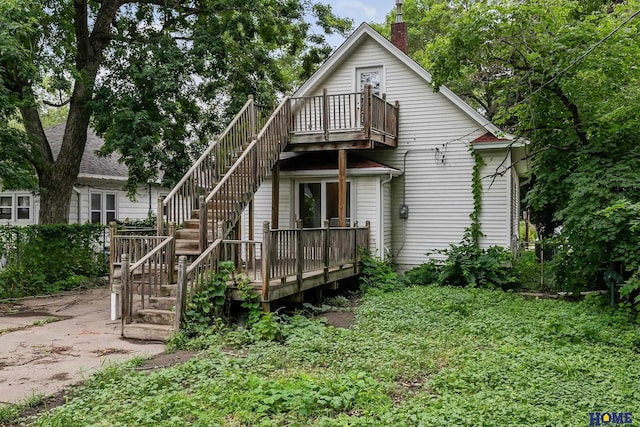 back of property with a wooden deck