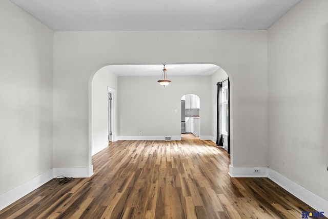 spare room with dark wood-type flooring