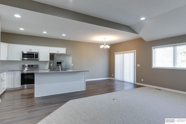 kitchen featuring white cabinets, a center island, dark hardwood / wood-style flooring, and appliances with stainless steel finishes