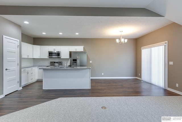 kitchen featuring white cabinets, dark hardwood / wood-style floors, hanging light fixtures, and appliances with stainless steel finishes