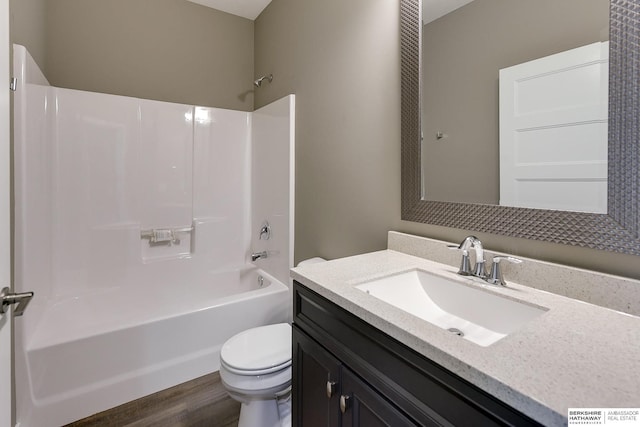 full bathroom with hardwood / wood-style floors, vanity, toilet, and bathing tub / shower combination