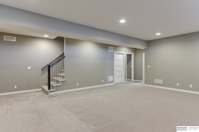 basement featuring light colored carpet