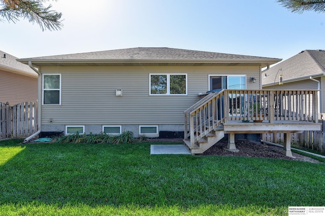 back of property featuring a lawn and a wooden deck