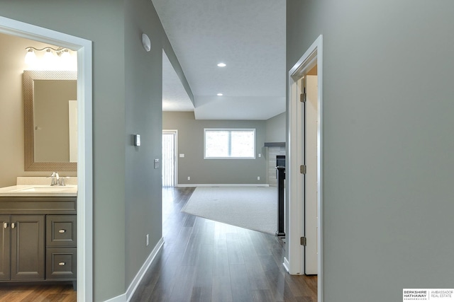 hall featuring hardwood / wood-style flooring and sink