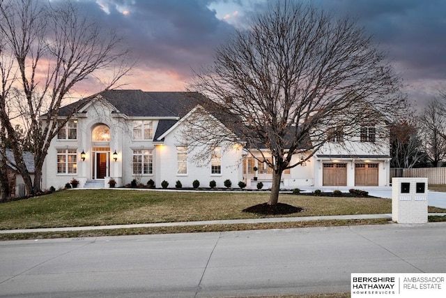 view of front of home featuring a yard and a garage