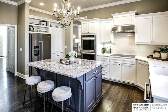 kitchen with a center island, dark hardwood / wood-style floors, ventilation hood, crown molding, and white cabinets