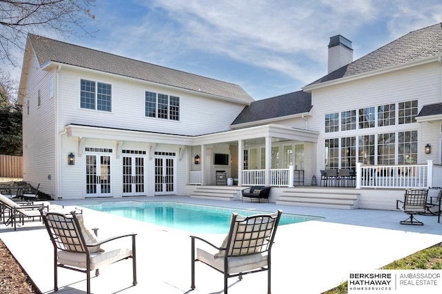 view of pool featuring a patio and french doors