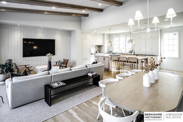 living room with beam ceiling and light hardwood / wood-style flooring