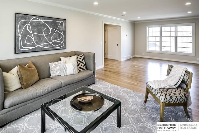 living room featuring hardwood / wood-style flooring and ornamental molding