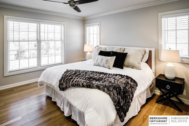 bedroom featuring multiple windows and hardwood / wood-style flooring