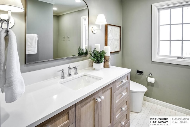 bathroom with tile patterned floors, vanity, toilet, and crown molding