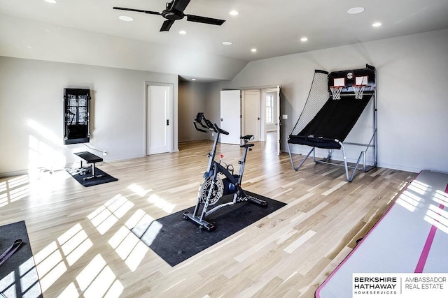 exercise area featuring ceiling fan, light wood-type flooring, and lofted ceiling