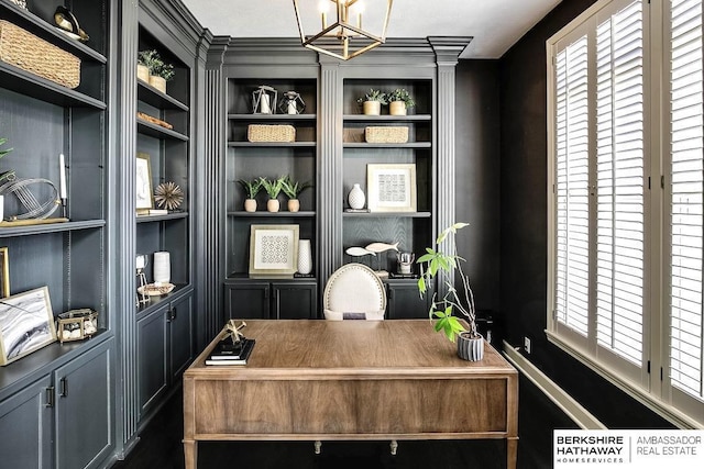 office featuring built in shelves and a chandelier