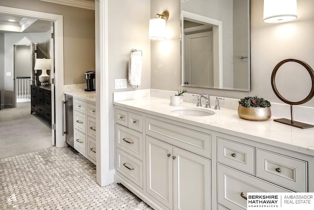 bathroom featuring vanity and ornamental molding