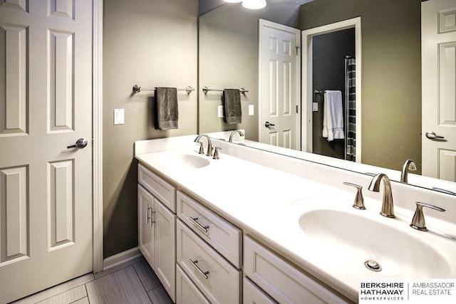 bathroom with tile patterned flooring and vanity