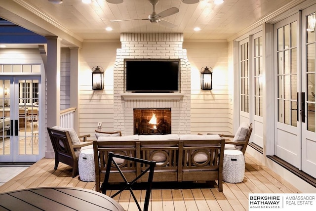 wooden terrace with ceiling fan and a brick fireplace