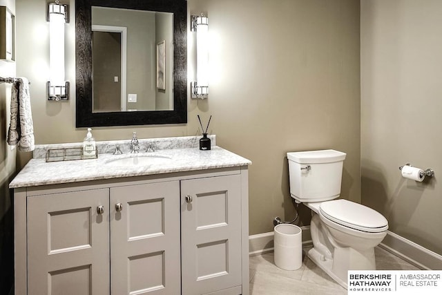 bathroom with tile patterned floors, vanity, and toilet