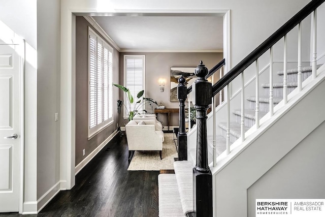 entrance foyer with dark hardwood / wood-style floors and crown molding