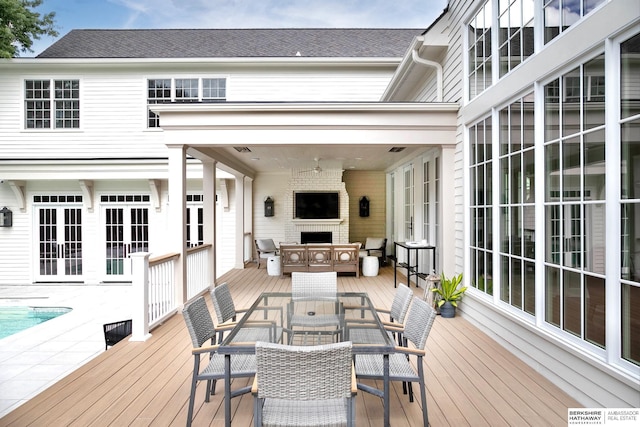 wooden deck with a fireplace