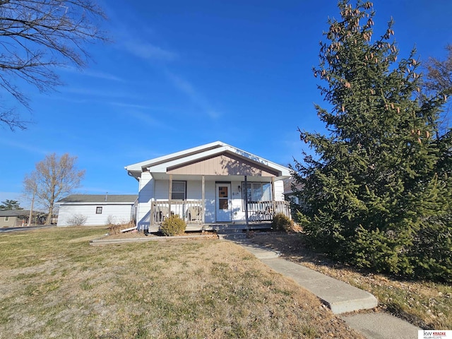 bungalow-style house with covered porch and a front yard