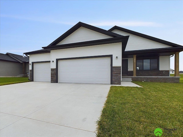 view of front of property with a garage, concrete driveway, and a front yard