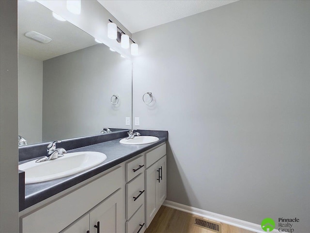 bathroom featuring vanity and hardwood / wood-style flooring