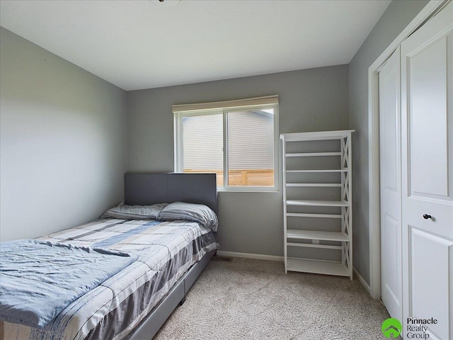 bedroom featuring light colored carpet and a closet