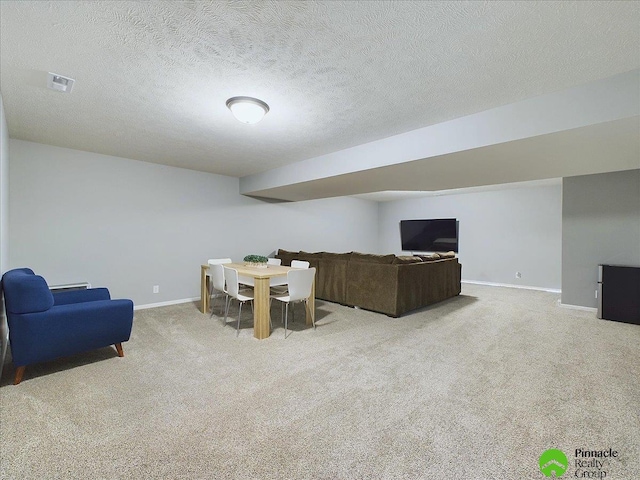 carpeted living room featuring a textured ceiling